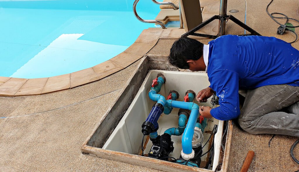pool maintenance specialist from Luminous engineering singapore checking serviceability of pool equipment